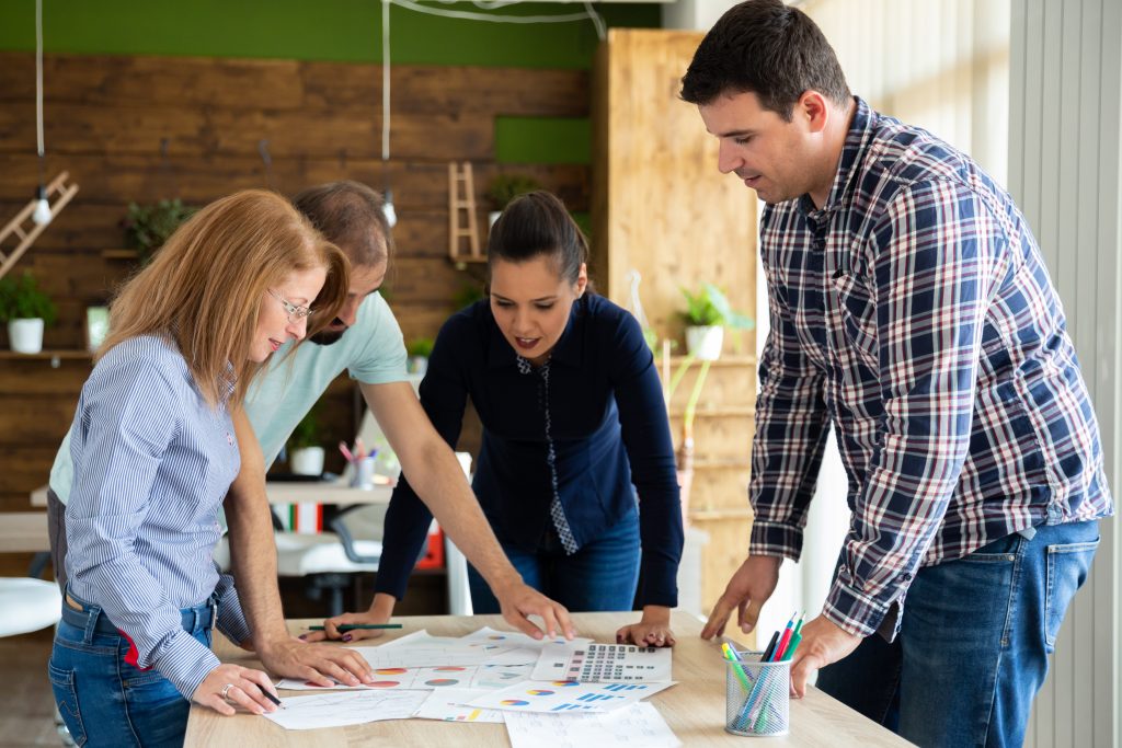 A team of professionals working together on a business strategy around an office table